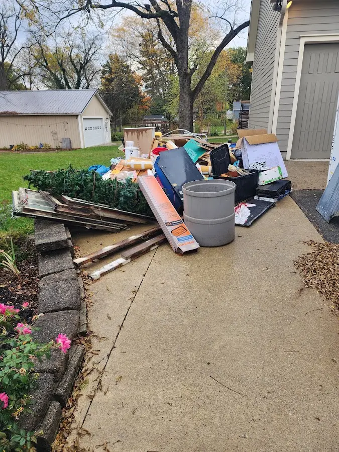 Dumpster being loaded with debris for Estate Cleanout Dumpster Rental in Lancaster